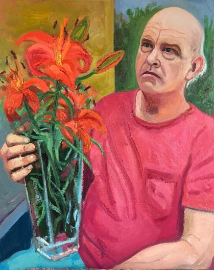 man in pink shirt and flower
