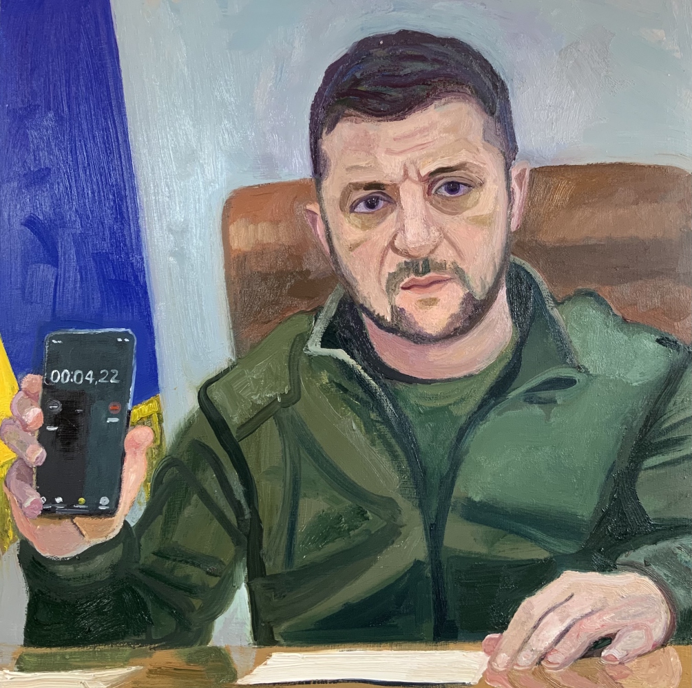 seated in chair holing a cellphone